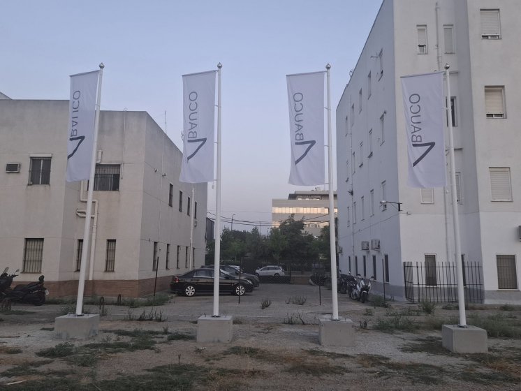 Mástil en fibra de vidrio con potencia y banderas. Dado de hormigón. Para Foro Consultores en Sevilla.