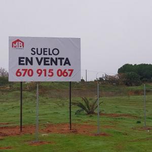 Valla cartelera panelable y rotulada con lona atornillada, para Grupo Inmobiliario MB Dos Hermanas Sevilla.